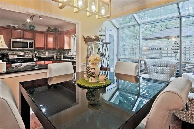 a living room with furniture and a view of kitchen