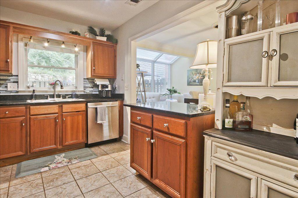 65 Mt Vernon Circle Sandy Springs, GA 30338 - Photo 18 of 44 a kitchen with stainless steel appliances granite countertop a stove a sink dishwasher and cabinets with wooden floor