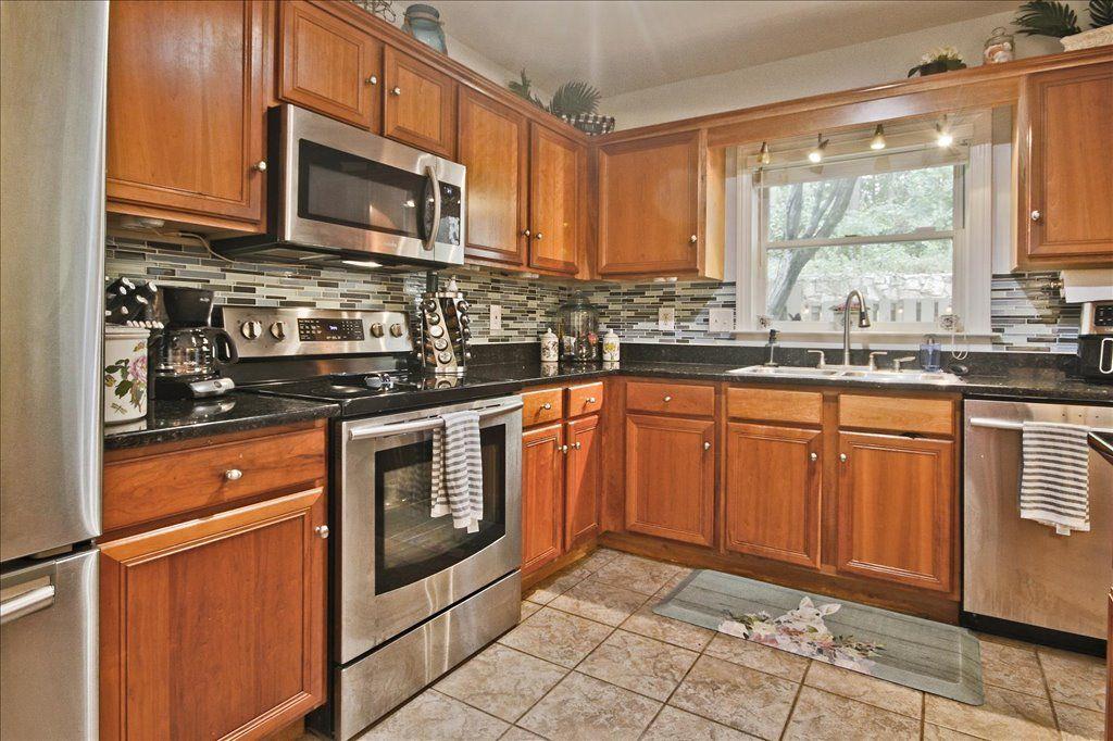 65 Mt Vernon Circle Sandy Springs, GA 30338 - Photo 19 of 44 a kitchen with stainless steel appliances granite countertop a stove microwave and sink
