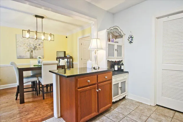 a kitchen with a sink and chairs