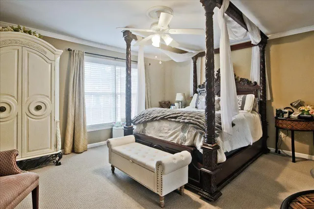 a spacious bedroom with a bed couch and a window