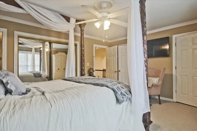a bedroom with a large bed and a chandelier