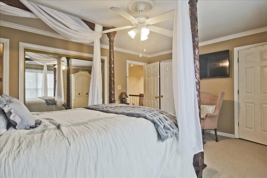 65 Mt Vernon Circle Sandy Springs, GA 30338 - Photo 25 of 44 a bedroom with a large bed and a chandelier