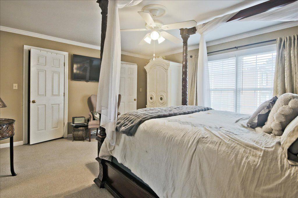 65 Mt Vernon Circle Sandy Springs, GA 30338 - Photo 26 of 44 a bedroom with a large bed and a chandelier