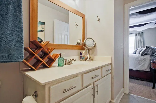 a en suite bathroom with a sink and mirror