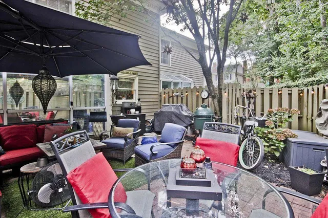 a view of outdoor sitting area with furniture and umbrella