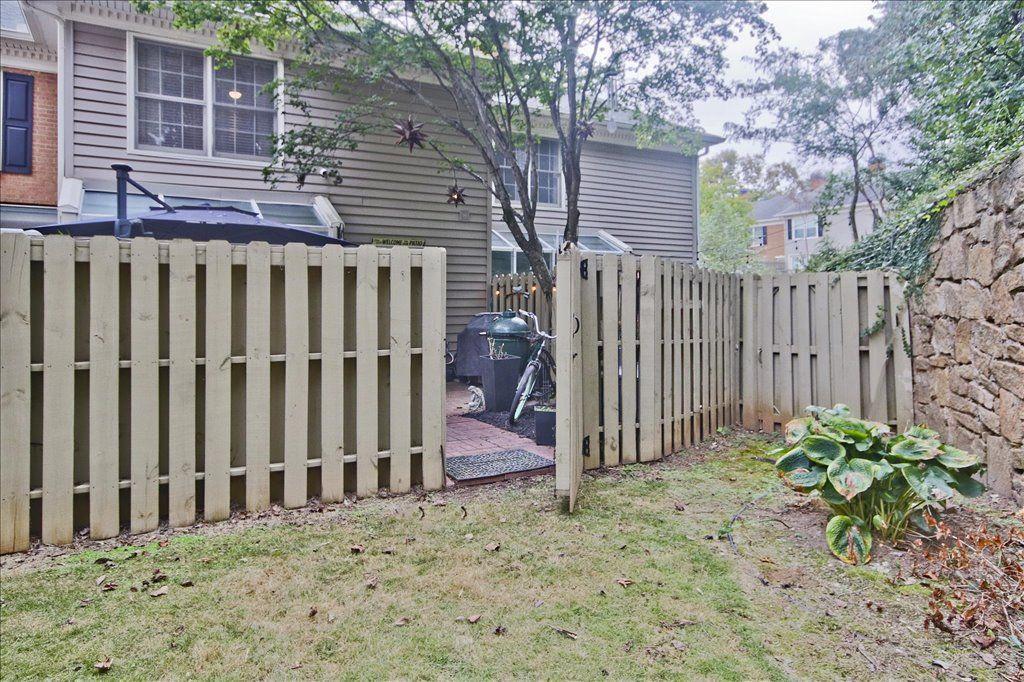 65 Mt Vernon Circle Sandy Springs, GA 30338 - Photo 37 of 44 a view of a house with a small yard and wooden fence