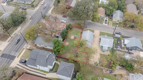 an aerial view of residential houses with outdoor space and street view
