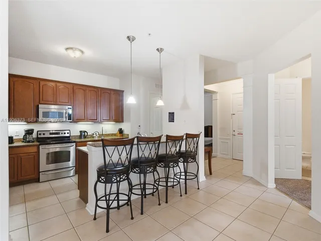 a large kitchen with a table and chairs