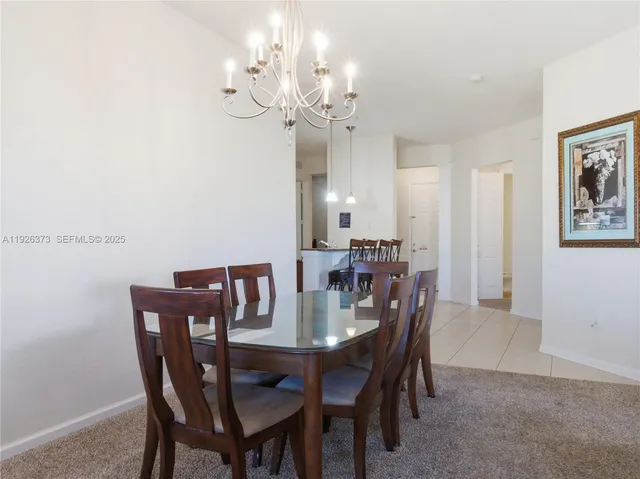 a view of a dining room with furniture and chandelier