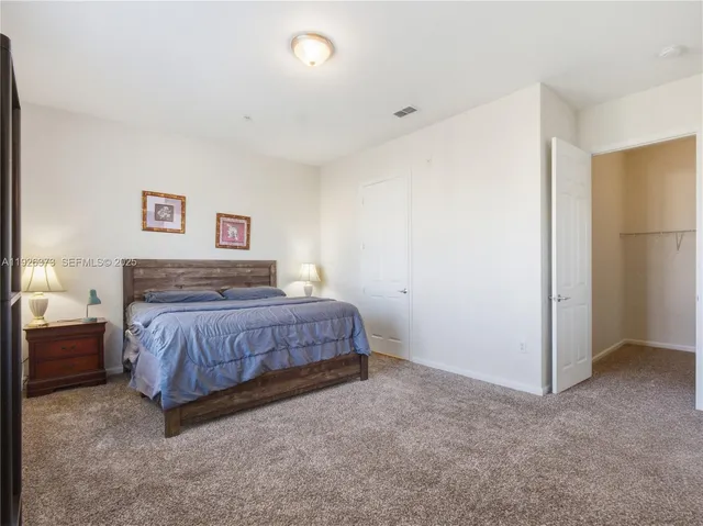 a bedroom with a bed and a night stand