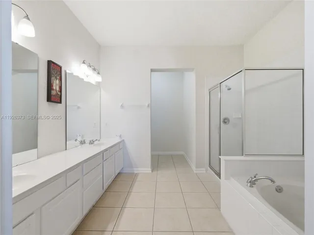 a bathroom with a tub sink and mirror