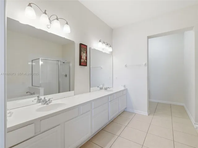 a bathroom with a double vanity sink mirror and
