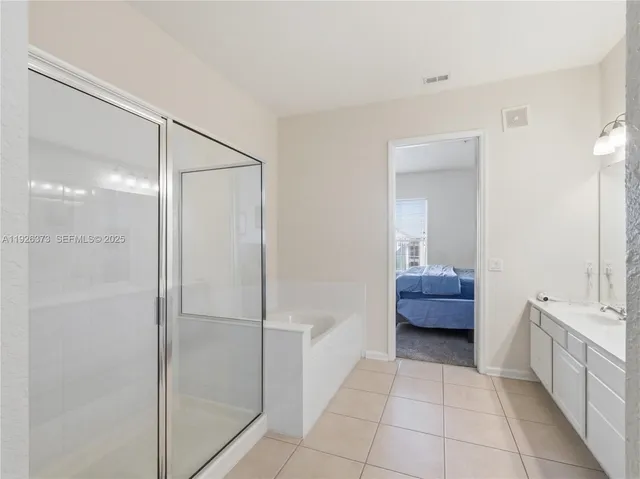a bathroom with a tub mirror and toilet