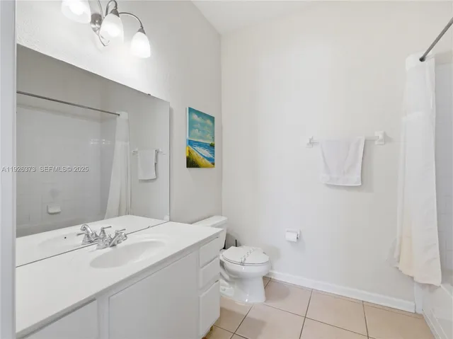 a bathroom with a sink a toilet and vanity