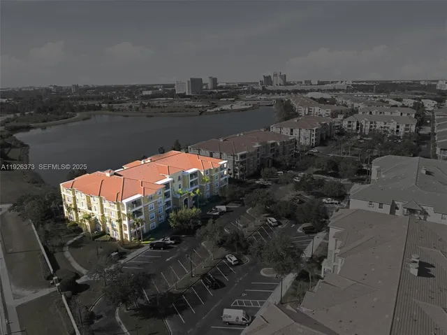an aerial view of a house with a lake