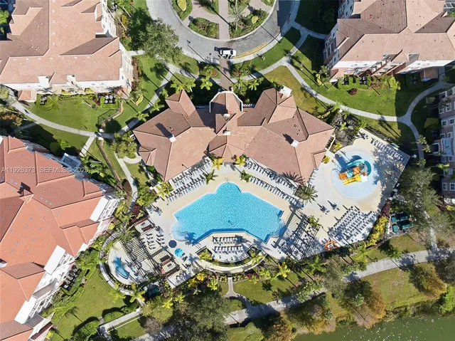 an aerial view of a house with a yard and garden