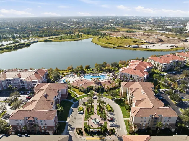 an aerial view of ocean and residential houses with outdoor space