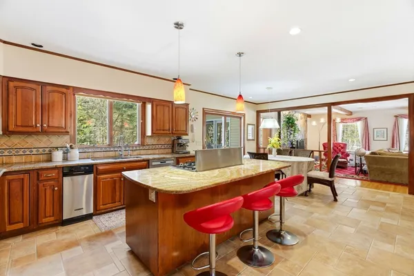a kitchen with granite countertop a sink a counter space appliances and cabinets
