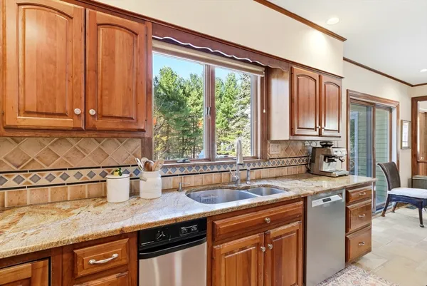 a kitchen with stainless steel appliances a bath table and chairs