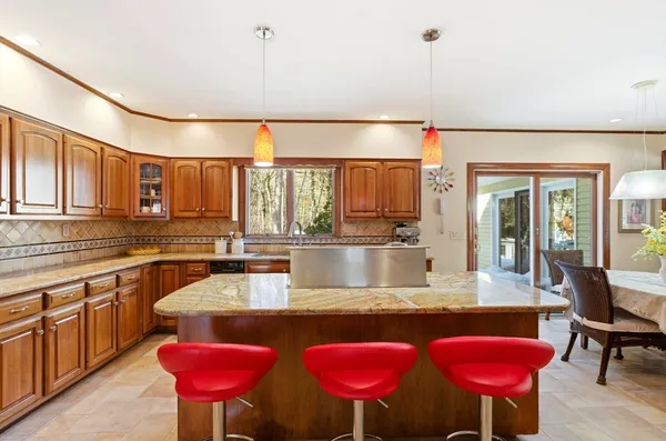 a kitchen with stainless steel appliances granite countertop a sink dishwasher and cabinets with wooden floor
