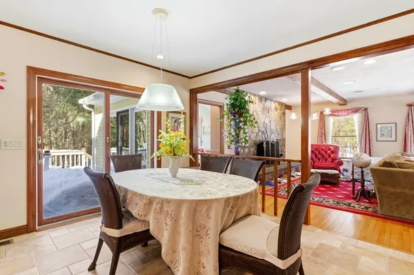 a kitchen with stainless steel appliances wooden floor dining table and chairs