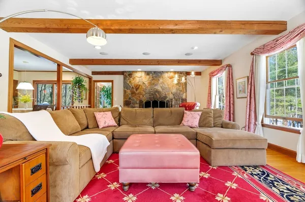 a living room with furniture a flat screen tv and a fireplace