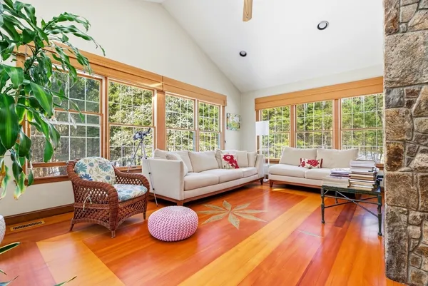 a living room with furniture and a floor to ceiling window
