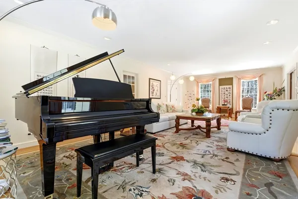 a living room with a coffee table and a piano table with wooden floor