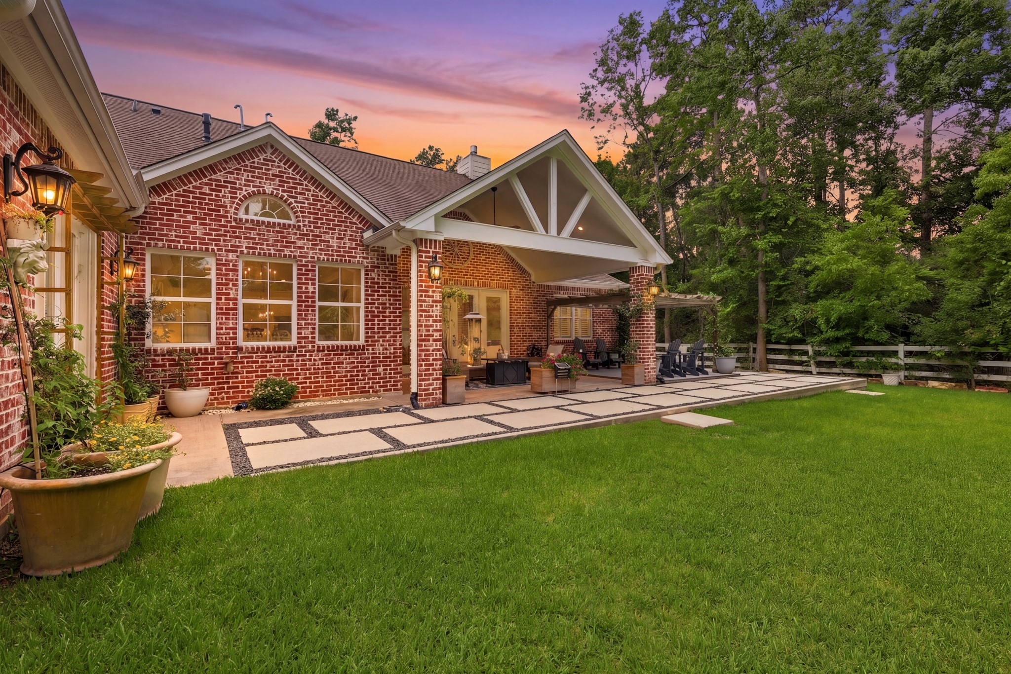 7106 Hampton Court Spring, TX 77389 - Photo 30 of 31 Charming brick home with a spacious, manicured backyard. It features a covered patio with seating, surrounded by lush greenery, perfect for outdoor relaxation and entertaining.