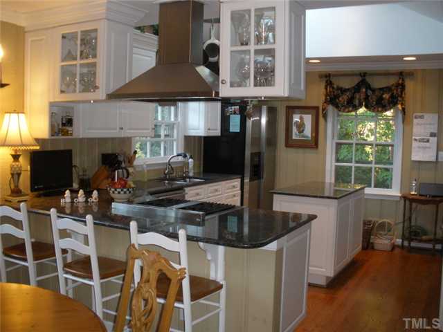 2633 Lakeview Drive Raleigh, NC 27608 - Photo 4 of 18 This picture says it all!!! This is a Culinary artist?s delight. Granite countertops, wine rack, glass cabinets, Bosch dishwasher, Thermador four burner stove.