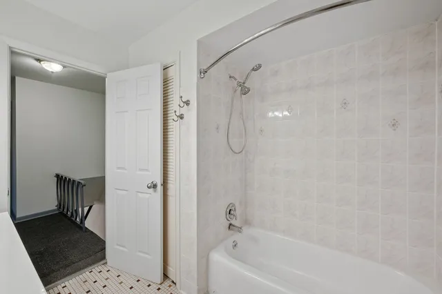 a bathroom with a bathtub and a shower