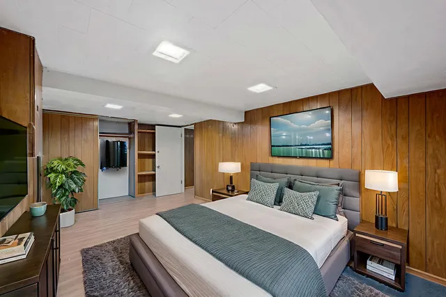 a bedroom with a large bed and a couch