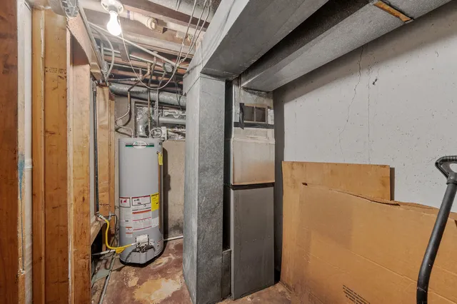 a view of a storage & utility room with refrigerator