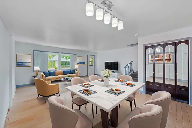 a living room with furniture a chandelier and a table