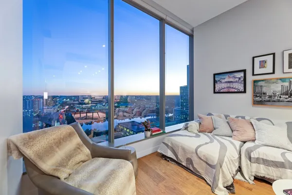 a bedroom with furniture and a view of balcony
