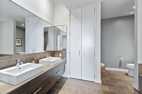a spacious bathroom with a double vanity sink and a mirror