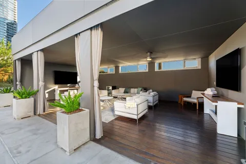 a view of outdoor sitting area with furniture and tub