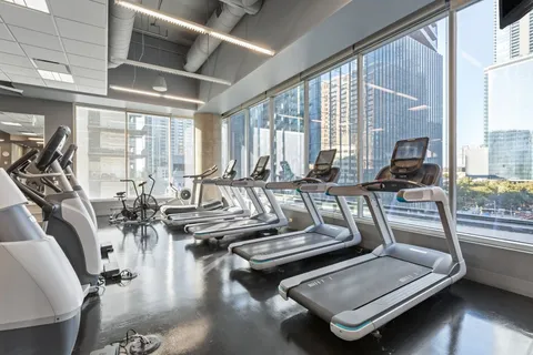 a kitchen with kitchen island stainless steel appliances a table and chairs in it