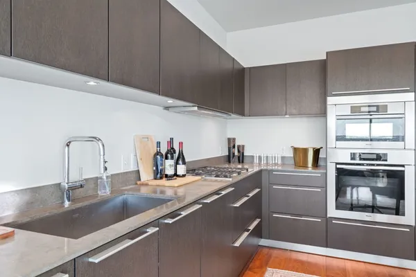 a kitchen with stainless steel appliances granite countertop a sink and a stove