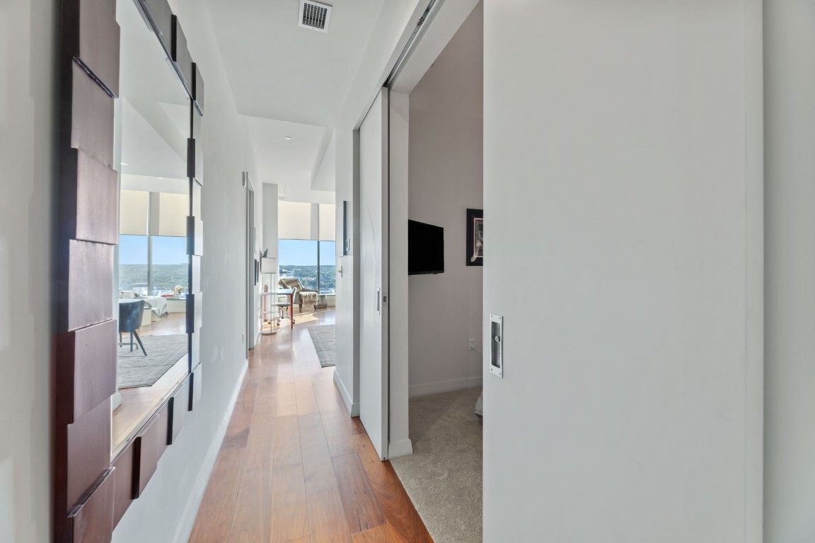 210 Lavaca Street, Unit 1902 Austin, TX 78701 - Photo 10 of 40 a view of a hallway with wooden floor and a living room