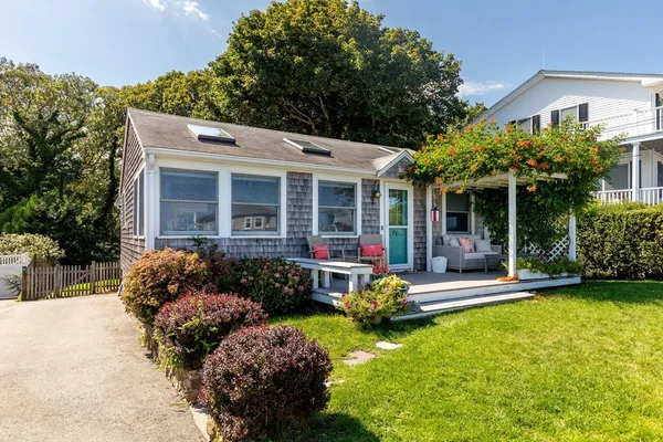 a front view of a house with a yard table and chairs
