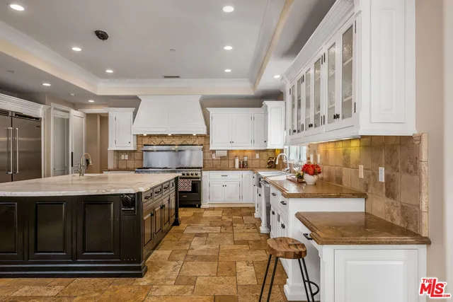 a kitchen with a stove a sink and a refrigerator