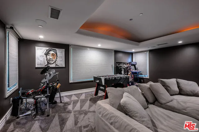 a media room with furniture a projector and a projector