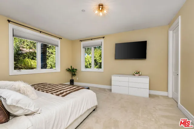 a spacious bedroom with a bed and a walk in closet