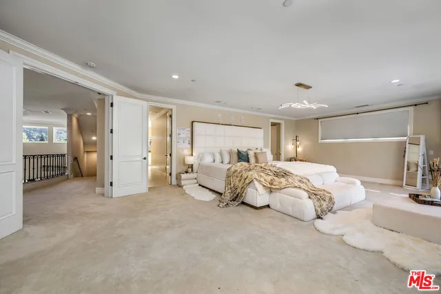 a spacious bedroom with bed and a large window