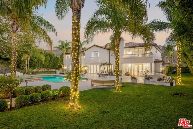 a work room with furniture a flat screen tv and a window