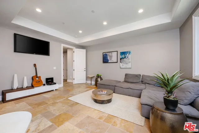 a front view of a house with a yard and potted plants