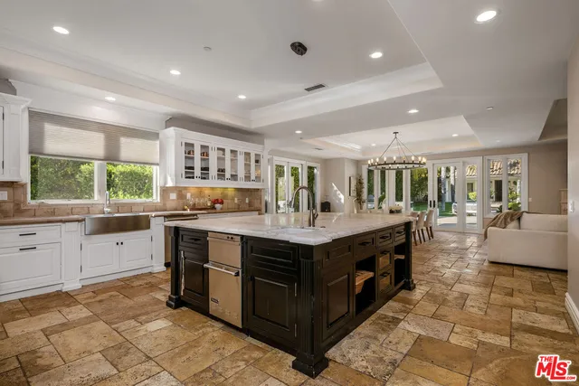 a large kitchen with kitchen island granite countertop a large counter top and sink