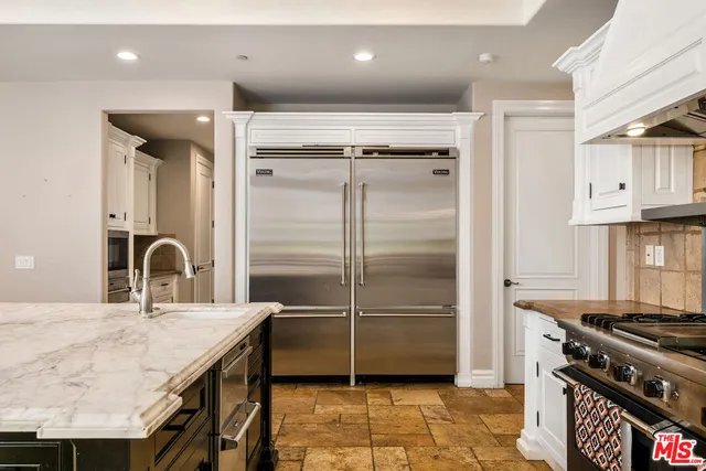 a kitchen with stainless steel appliances granite countertop a stove a refrigerator and a refrigerator